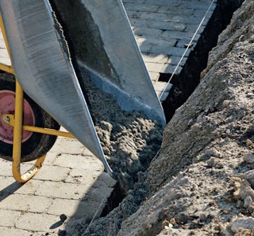 Flott hagemur i gatestein: Grøfta til fundamentet fylles opp med betong Flott hagemur i gatestein: Grøfta til fundamentet fylles opp med betong